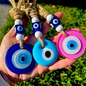 Evil eye glass amulets in pink, blue and baby blue.